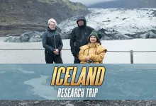 Three people stand in front of an Icelandic glacier beneath an Iceland Research Trip graphic.