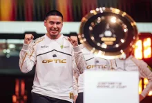 Shotzzy celebrates OpTic Gaming's Esports World Cup victory beside the tournament trophy