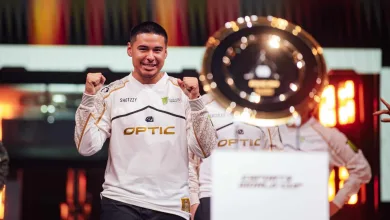 Shotzzy celebrates OpTic Gaming's Esports World Cup victory beside the tournament trophy