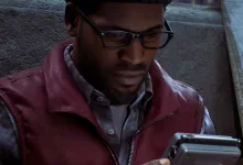 Simon holds a handheld device while standing in a dim, foggy setting in Silent Hill: Townfall