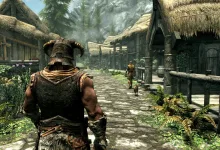 A helmeted Skyrim warrior stands on a village street surrounded by wooden buildings.