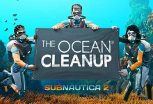 Three Subnautica 2 divers hold a sign reading The Ocean Cleanup above an underwater reef