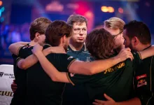 Counter-Strike esports players in dark jerseys huddle during the Esports World Cup 2026.