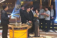 Team Spirit players gather onstage beside the championship trophy after winning The International 2026