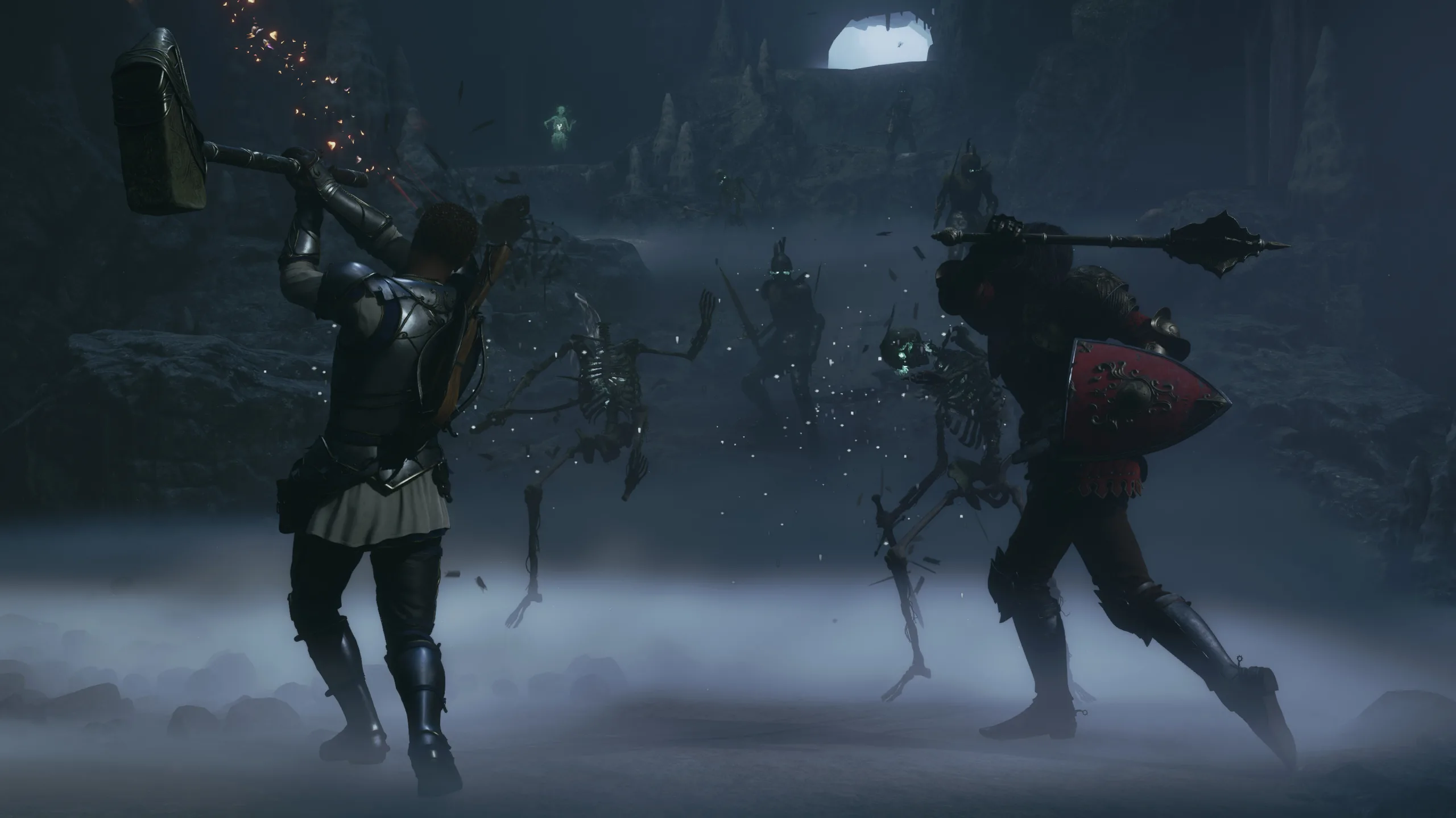 The Hero fights undead enemies inside a dark cavern with a heavy weapon.