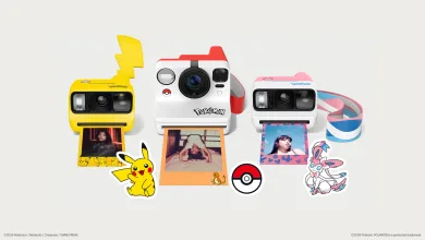 Three Pokémon-themed Polaroid cameras displayed with Pokémon accessories, including Pikachu and Sylveon designs and a Poké Ball