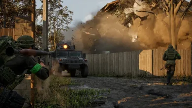 Soldiers take cover near a military vehicle as a structure collapses in a wooded combat area.