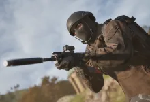 A masked WARDOGS soldier aims a suppressed rifle outdoors with a blurred industrial battlefield in the background.