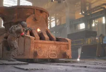 A Wardogs soldier fires from cover beside industrial machinery inside a factory.