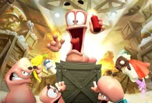 Cartoon worms gather around a wooden crate during an explosive scene.