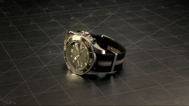 A Q-Watch from 007 First Light rests on a dark workbench.