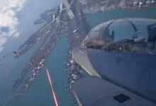 A fighter aircraft banks over a coastal city as a red weapon beam crosses the scene in Ace Combat 8: Wings of Theve.
