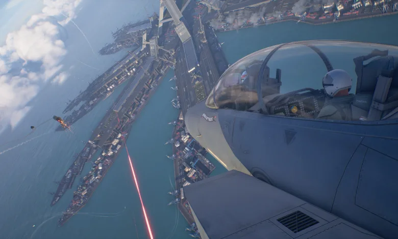 A fighter aircraft banks over a coastal city as a red weapon beam crosses the scene in Ace Combat 8: Wings of Theve.