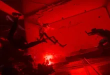 Hostile entities move through a red-lit room in Control Resonant.