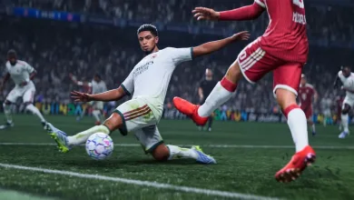 EA Sports FC 27 players contesting the ball during a match, with a player in white sliding against an opponent in red
