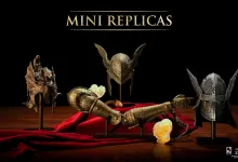 Four Elden Ring display replicas arranged on a red cloth, including Malenia's prosthetic arm and helmets for Malenia, Messmer and Wylder