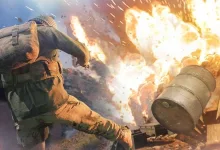 An Enlisted soldier is thrown backward as a large explosion erupts beside battlefield debris.