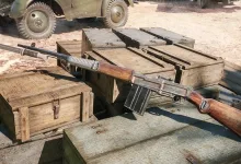 The ZH-32 rifle rests across wooden crates in an Enlisted scene.