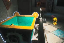Gameplay shows a small yellow toy character beside a large outlined container in a dim factory interior.