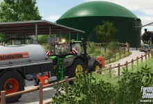A Farming Simulator 25 tractor pulls a Schouten slurry tanker beside a large green biogas tank.