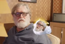 Gabe Newell sits in an office beside a small winged, haloed version of himself in a humorous composite image.