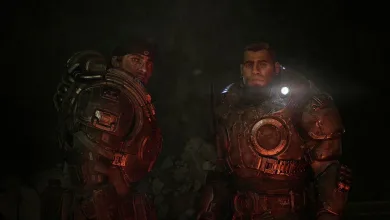 Two armored Gears of War: E-Day characters stand in a dark cavern illuminated by red and white light.