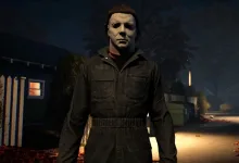 Michael Myers stands on a dark residential street at night in Halloween: The Game.