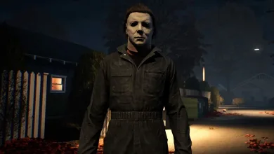 Michael Myers stands on a dark residential street at night in Halloween: The Game.