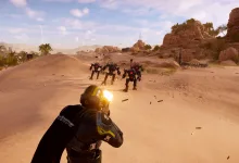 A Helldivers 2 soldier fires at enemies across a desert battlefield.