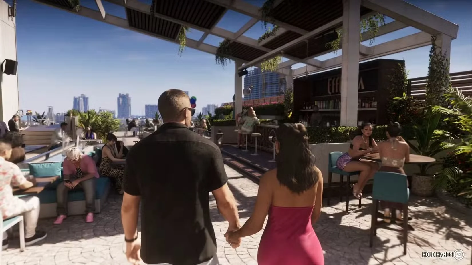 Jason and Lucia hold hands at an outdoor venue