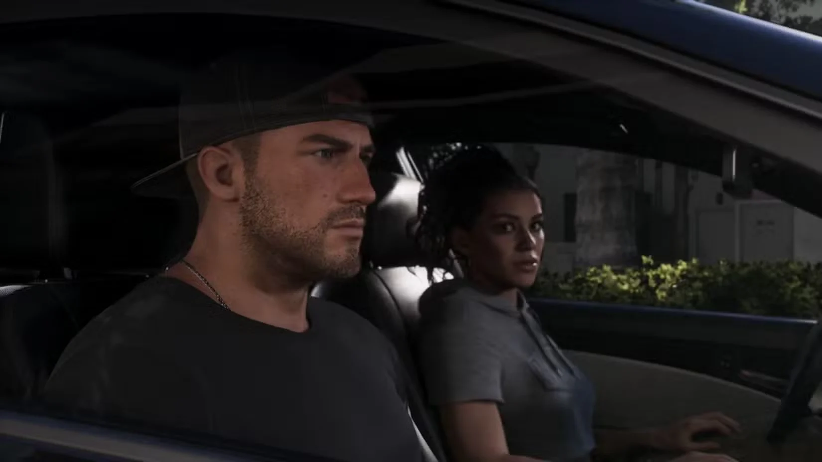Jason drives while Lucia sits beside him in a car