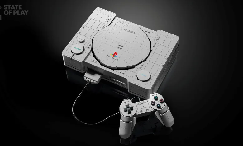 A LEGO replica of the original PlayStation console with its wired controller on a dark background.