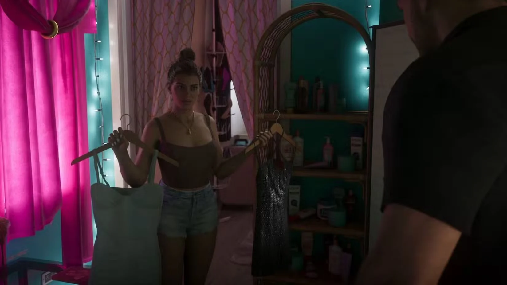 Lucia holds clothing while Jason stands nearby in a room