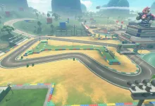 Aerial view of a Mario Kart World racetrack with colorful barriers, surrounding roads, and Mario-themed structures.