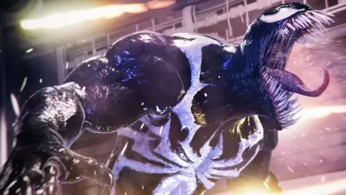 Venom lunges toward the viewer in a dark, illuminated action scene.