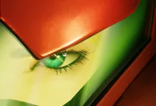 Close-up of Samus's eye beneath her red helmet in Metroid Ravenous