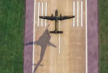 Vintage racing aircraft viewed from above as it lines up over a runway in Microsoft Flight Simulator 2024