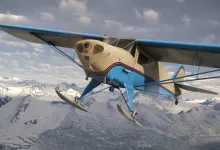 The Taylorcraft BC-12D ski-equipped aircraft flies over snow-covered mountains in Microsoft Flight Simulator 2024.