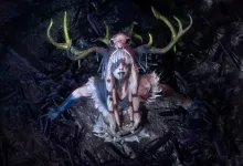 Path of Exile 2 trailer scene showing an antlered figure facing the sky in a dark setting