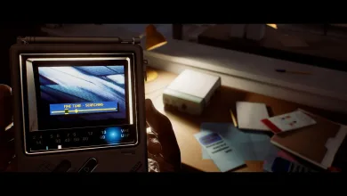 A first-person view shows a hand holding the CRTV handheld device over a desk in Silent Hill: Townfall