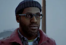The protagonist of Silent Hill: Townfall stands in a foggy setting wearing glasses, a knit cap, and a red vest.