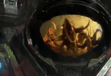 A red StarCraft mech helmet reflects an alien figure in its visor.