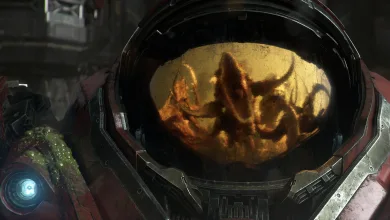 A red StarCraft mech helmet reflects an alien figure in its visor.
