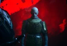 A bald vampire stands in dark armor against a vivid red sky in The Blood of Dawnwalker