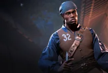 A THE FINALS contestant in a blue head covering and brown vest stands against a dark urban background.