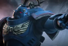 A blue-armored Space Marine points forward in a smoky battlefield scene.