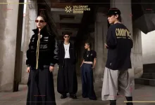 Models wearing pieces from the VALORANT Champions Shanghai merch collection outside a building