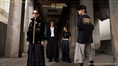 Models wearing pieces from the VALORANT Champions Shanghai merch collection outside a building