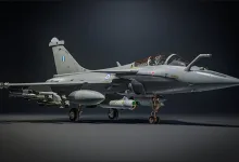 A Greek-marked Rafale EG fighter aircraft carrying missiles against a dark background