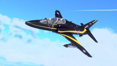 A black-and-yellow Hawk T Mk1A jet flying against a blue sky with clouds.